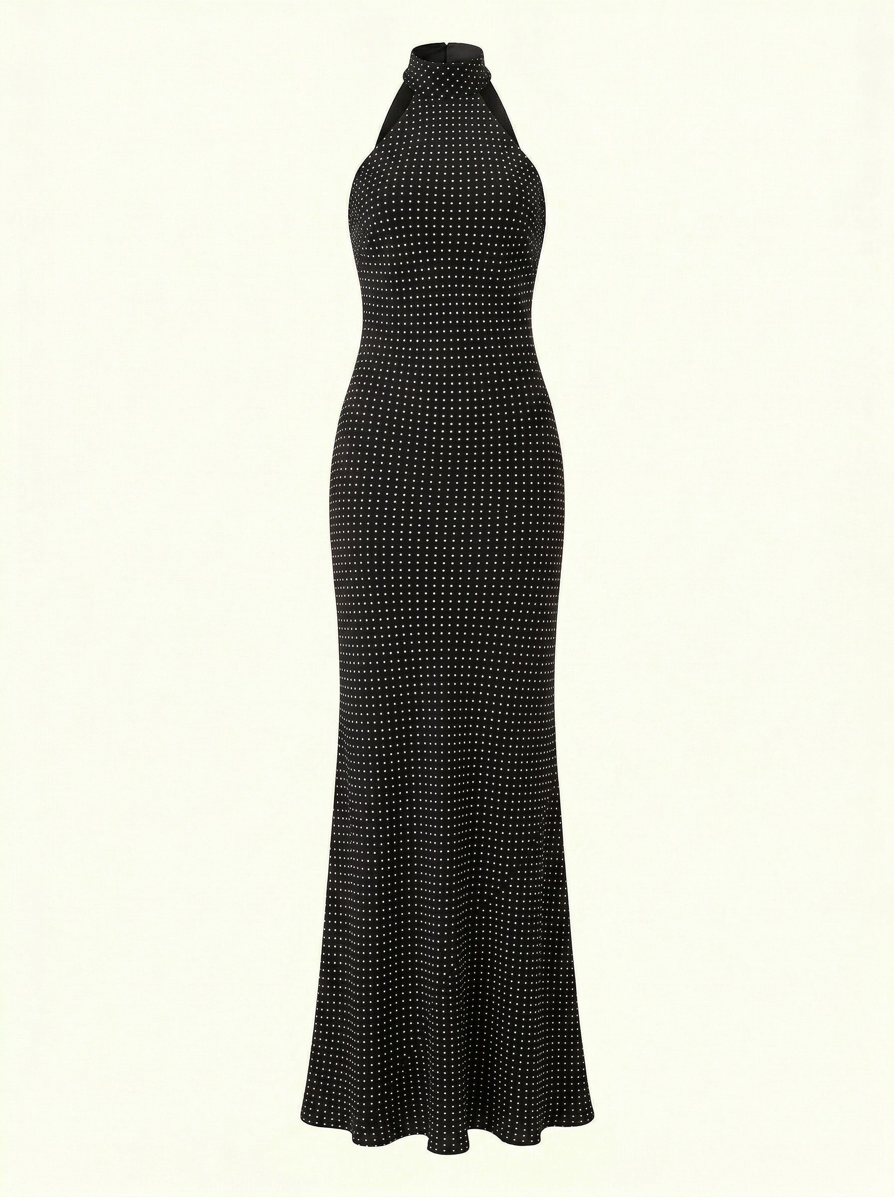 Black halter neck dress with white polka dots on a white background