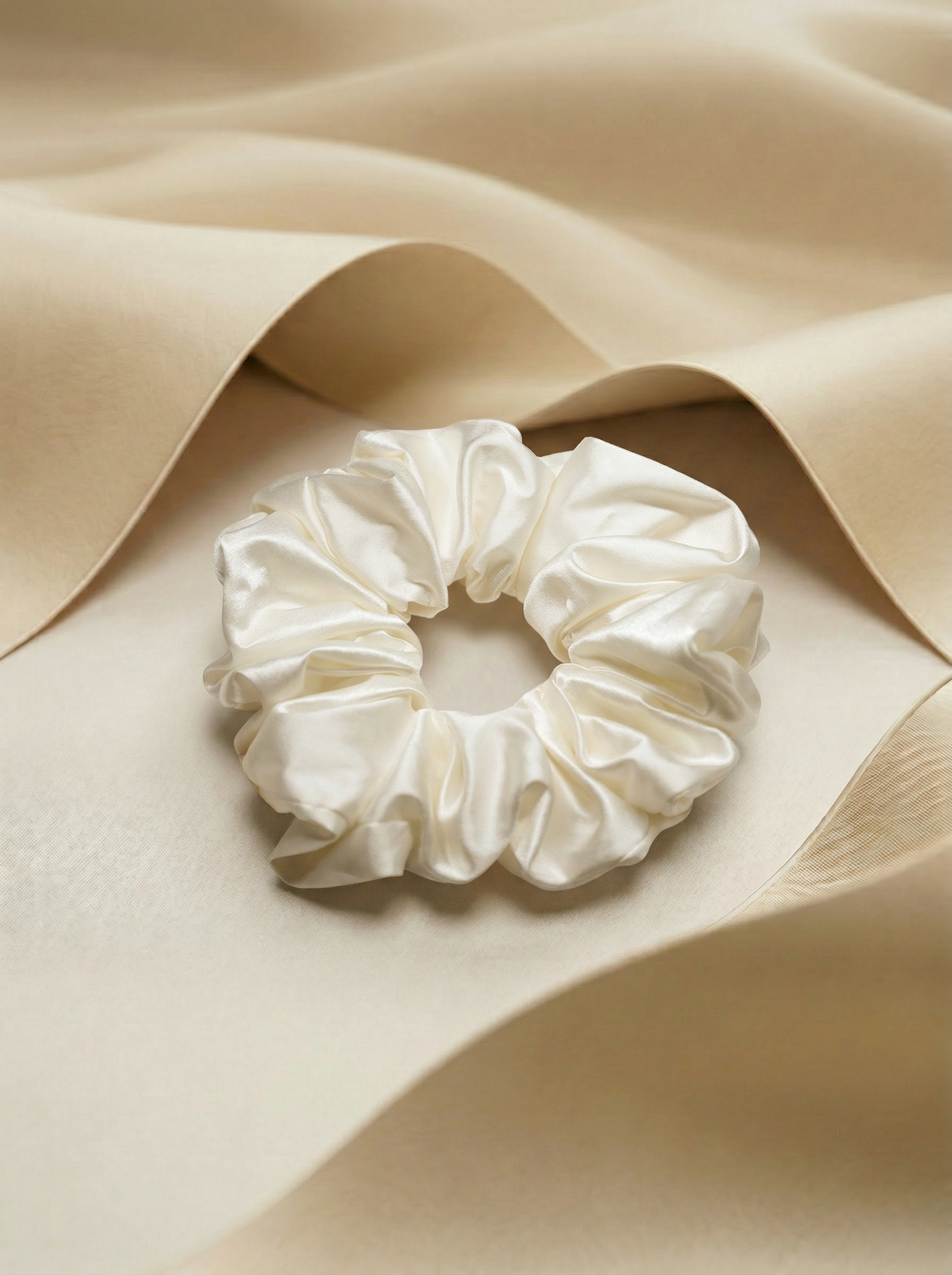 ivory silk scrunchie on beige fabric